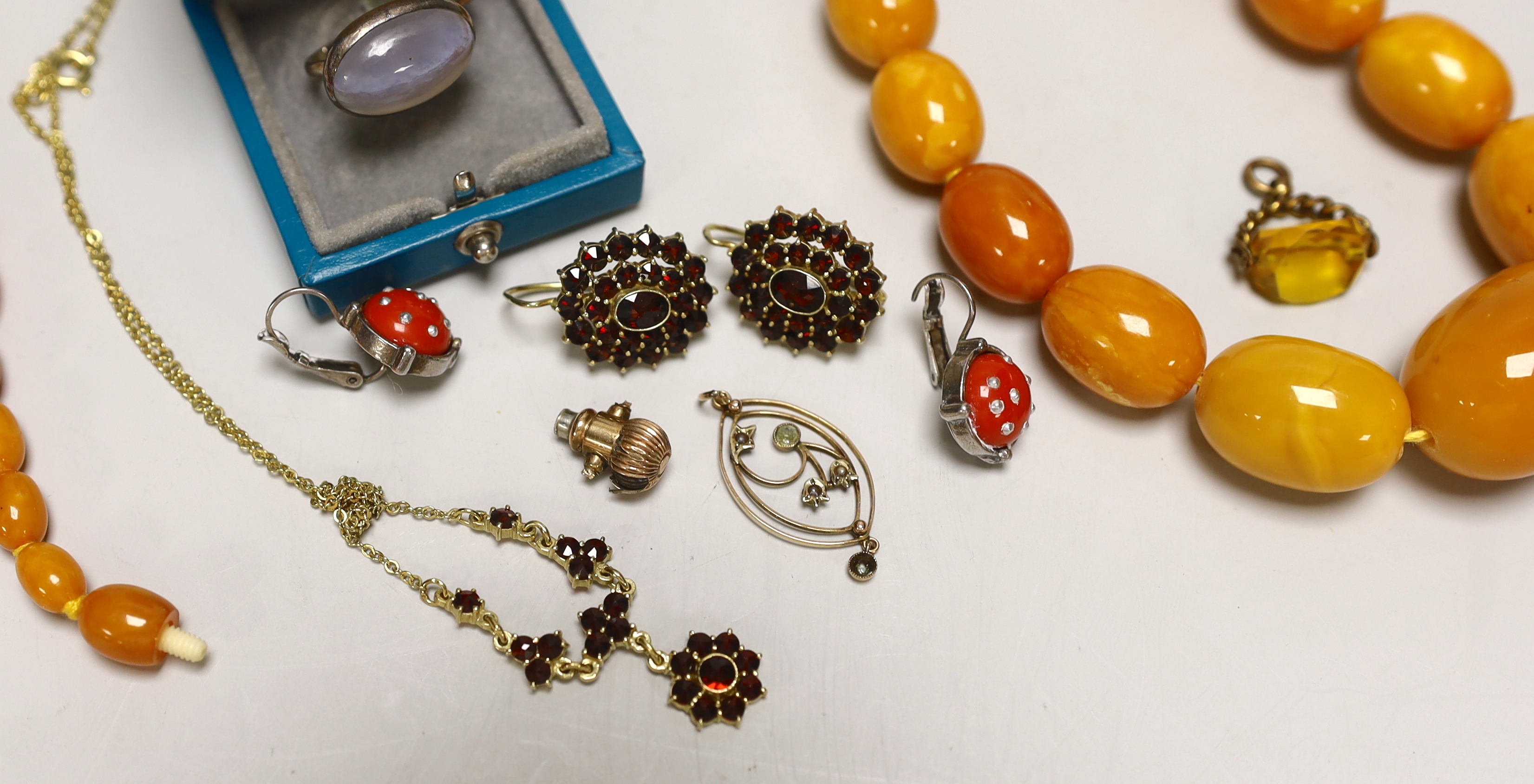 A single strand graduated oval amber bead necklace, 98cm, gross weight 94 grams and other sundry jewellery.